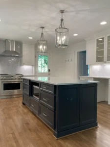 North Raleigh kitchen remodel by A&M Remodeling featuring open layout, large center island, custom cabinets, and hardwood floors