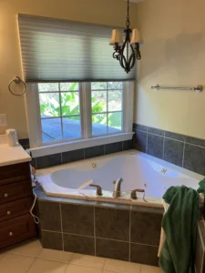Original garden tub area with dated finishes
