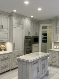 Remodeled North Raleigh kitchen featuring modern gray cabinets, neutral gray marble countertops, and new appliances.