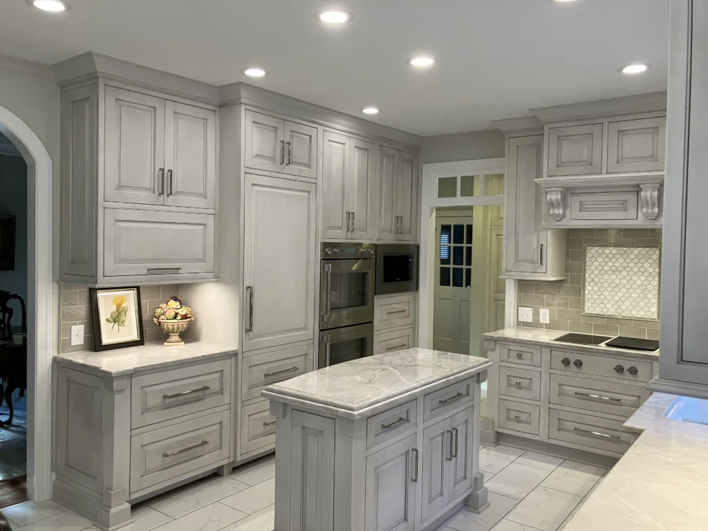 Updated kitchen with sleek inlay-door gray cabinetry and a soft gray marble countertop creating a fresh, contemporary look.