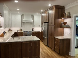 After kitchen remodel in North Raleigh featuring expanded layout, custom cabinetry, large island, and refinished hardwood floors by A&M Remodeling.