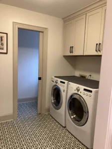 Clean and functional laundry room with built-in cabinets, countertop workspace, and modern appliances designed for efficient everyday use.